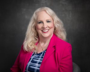 Sandy Eulitt, Life Backup Plan CEO and Founder in navy and white dress with fuchsia jacket