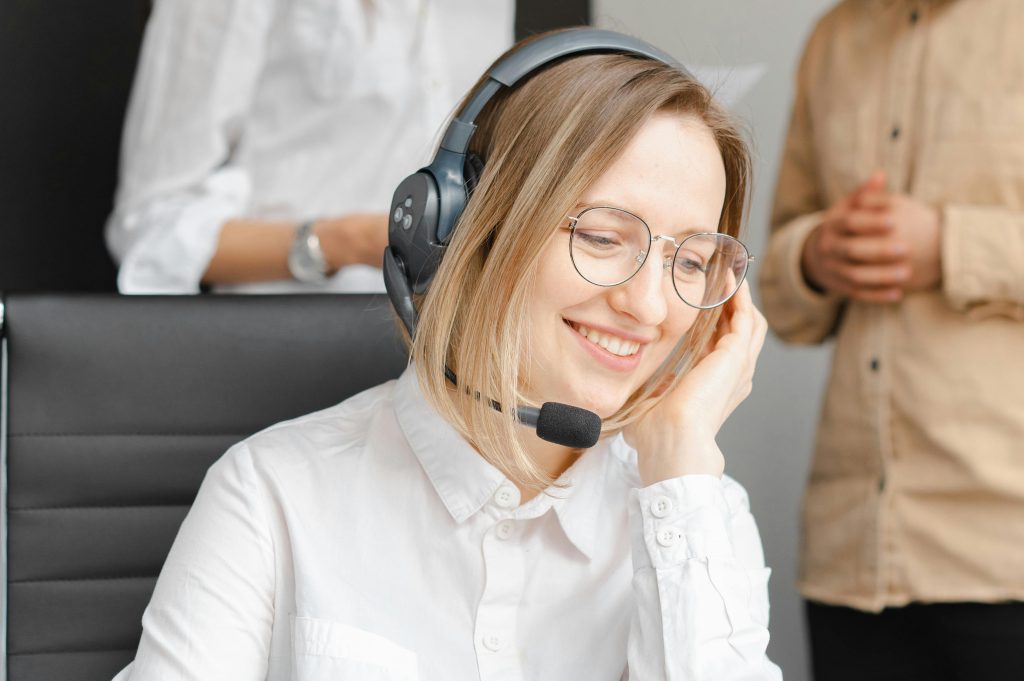 Blonde woman wearing a Plantronics headset with microphone, depicting the original SANDi - Sound Advantage Natural Dialogue interface